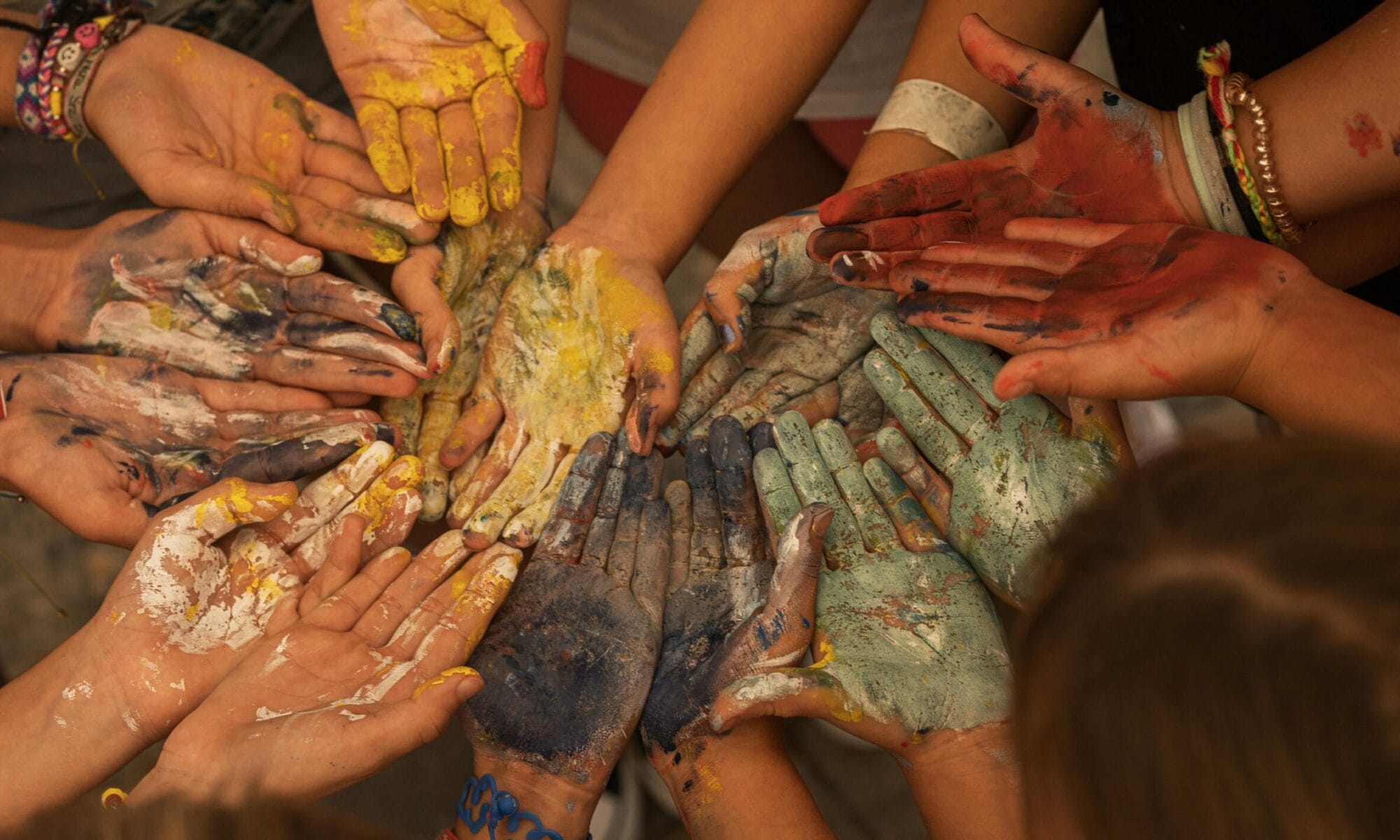 Photo by Raúl Castaños: https://www.pexels.com/photo/close-up-of-people-with-their-hands-painted-with-variety-of-colors-25682484/